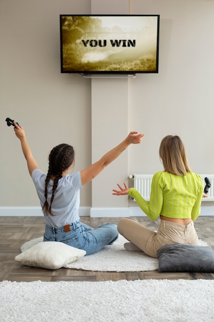 Young women playing video games together