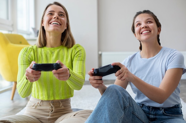 Young women playing video games together