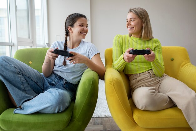 Young women playing video games together