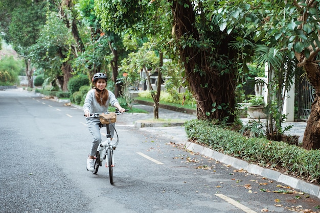 Young women riding folding bikes on the road