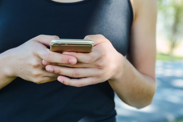 Young women's hands holding smartphone.