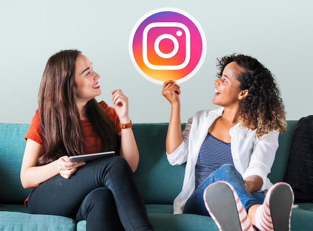 Photo young women showing an instagram icon