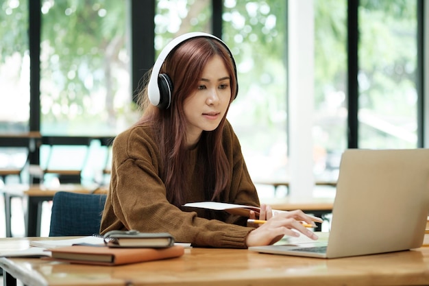 Photo young women study in front of the laptop computer at home