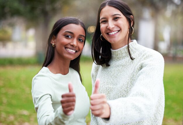 Photo young women thumbs up and university students happy for education or yes for academic study or success portrait and on mock up agreement female scholars and smile or achieve in new york campus