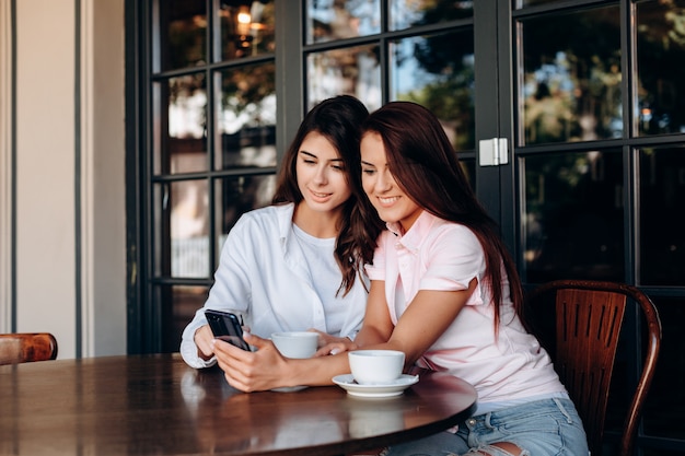 Young women watching in the smartphone in the cafe