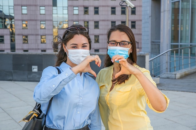 Young women wearing face masks outdoors