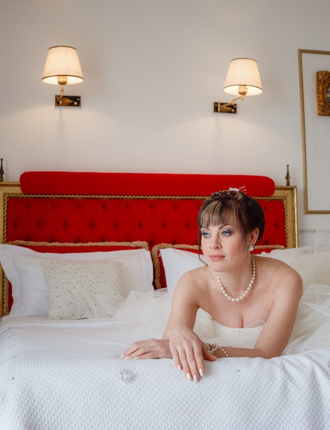 Young women with wedding dress in very bright room