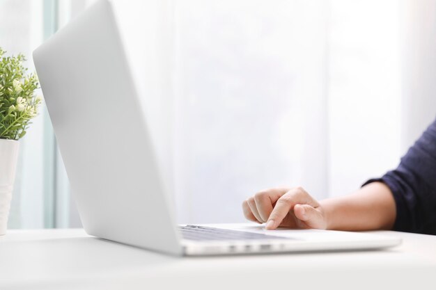 Young women working on her laptop in office.