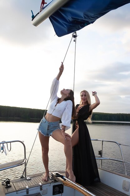 Young women on yacht at sunset