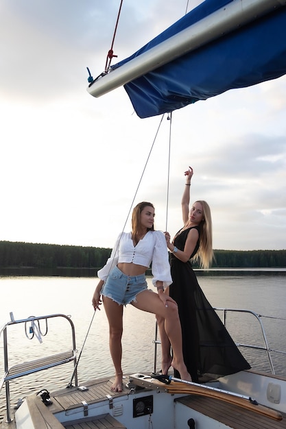 Young women on yacht at sunset