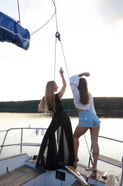 Young women on yacht at sunset