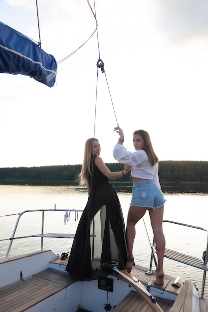 Young women on yacht at sunset