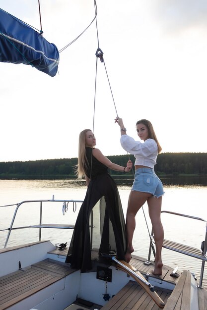 Young women on yacht at sunset