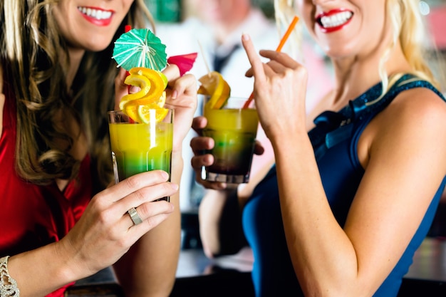 Young womens with cocktails in bar or club