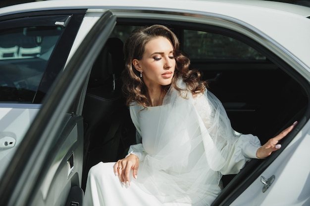 Young wonderful bride in the car