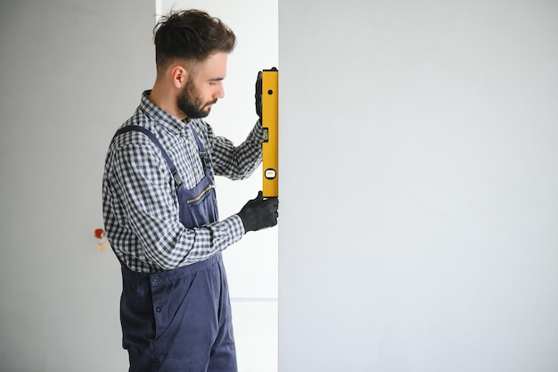 Young worker making repair in room