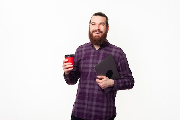 young worker man holding cup of coffee and laptop