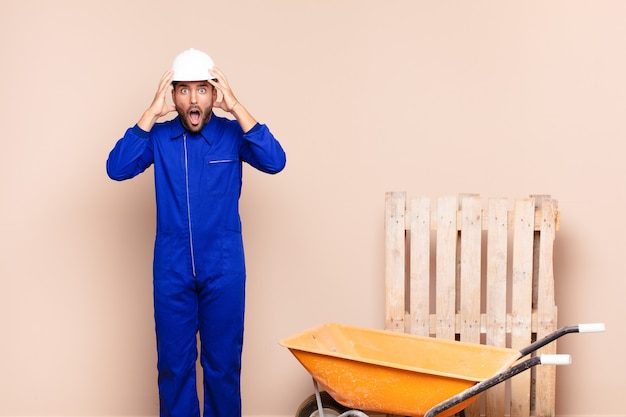 young worker man with a wheelbarrow