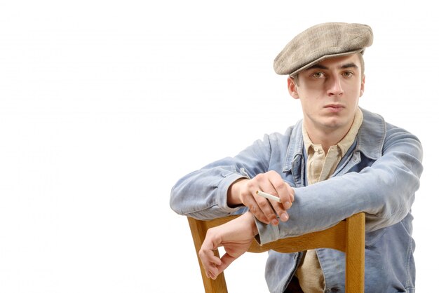 Young worker in vintage clothing sitting on a chair