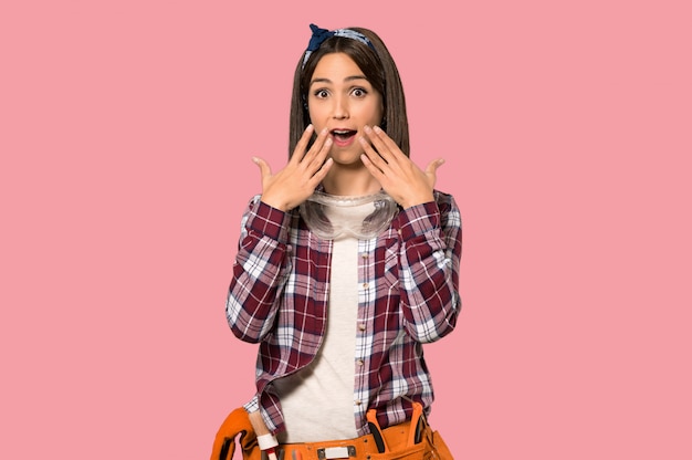 Young worker woman with surprise facial expression on isolated pink wall