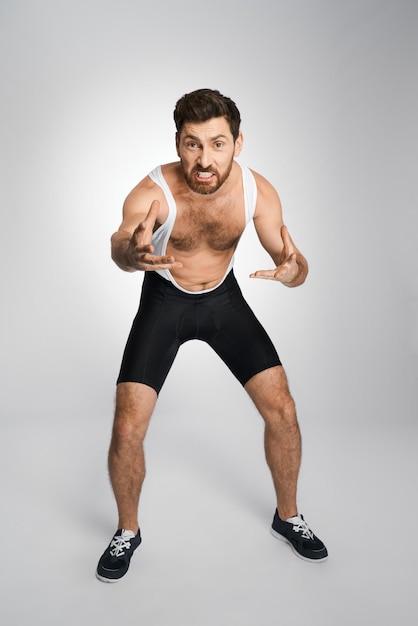 Young wrestler in black and white singlet getting ready to attack