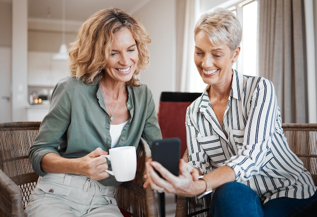 Your grandson has grown so much Shot of two female friends drinking coffee while using a digital tablet