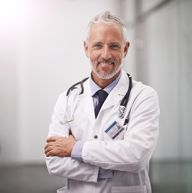 Your health is my happiness Cropped portrait of a mature doctor standing with his arms folded in the hospital corridor