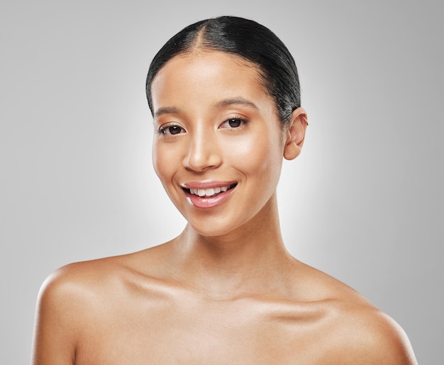 Your skin is beautiful, so wear it well. Studio portrait of an attractive young woman posing against a grey background.