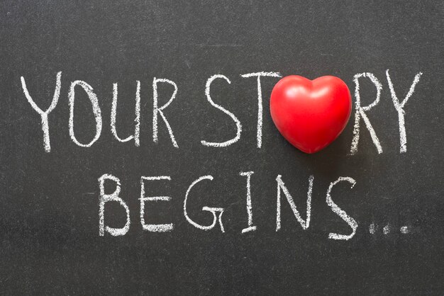 Your story begins phrase handwritten on chalkboard with heart symbol instead of O