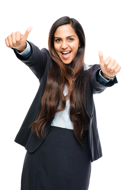 Youre doing a great job. Shot of a young businesswoman giving the thumbs up against a studio background.