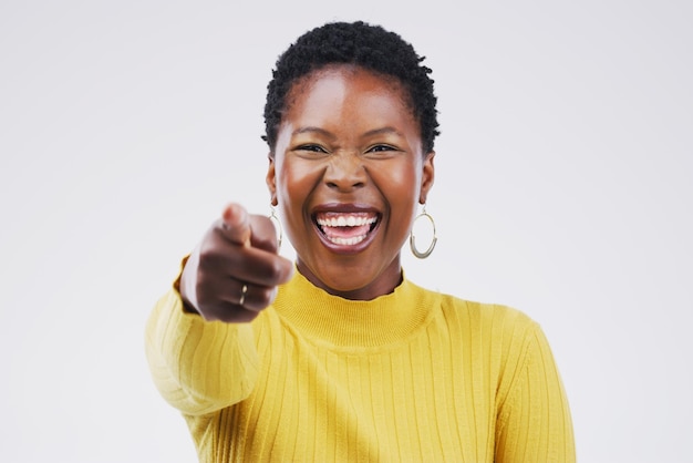 Youre fantastic Keep on shining Portrait of a beautiful young woman pointing to the camera against a grey background