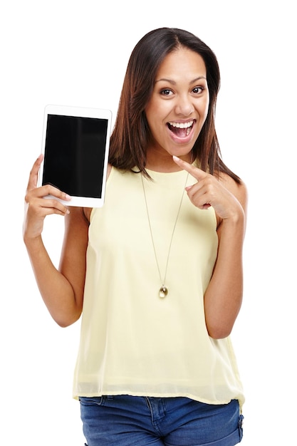Youre never alone with a tablet in your hand Portrait of an attractive young woman pointing at the digital tablet she is holding