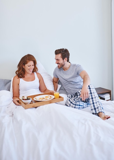 Youre a real darling for surprising me with breakfast Shot of a couple enjoying breakfast in bed together at home