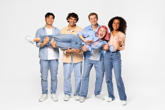 Youth and fun group of excited multiracial students holding friend and smiling at camera white