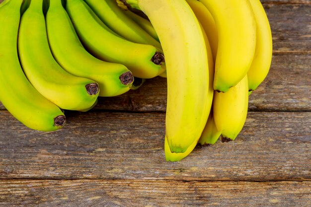 Yummy bananas on wooden background