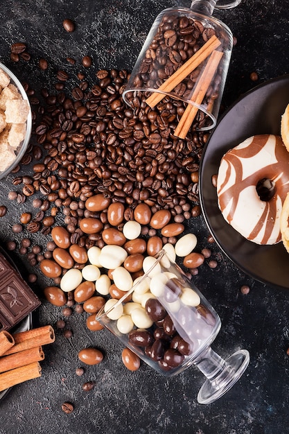 Yummy candies and sweets on a dark wooden board. Studio photo. Top view