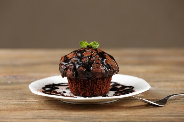 Yummy chocolate cupcake on table