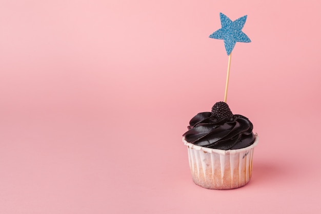 Yummy cupcake on light pink close up