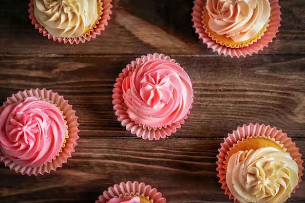 Yummy cupcakes on wooden table