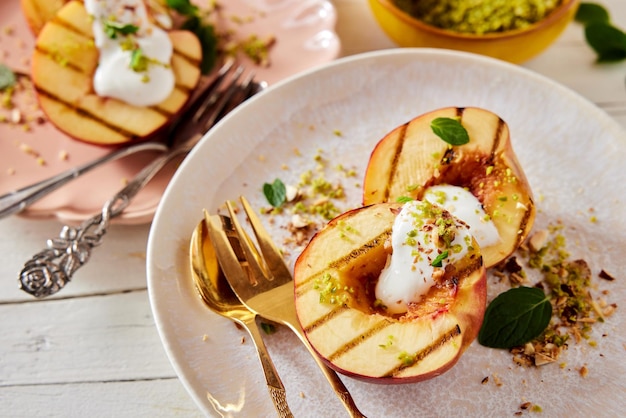 Yummy dessert with grilled nectarines on plate