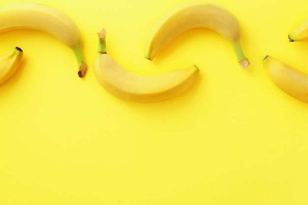 Yummy ripe bananas on color background