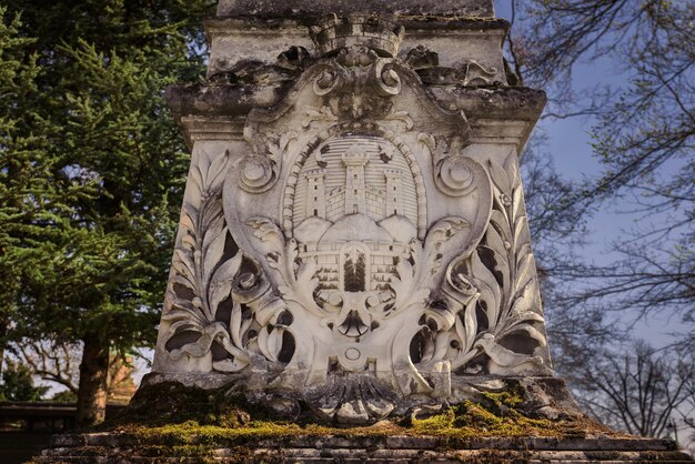 Zagreb Croatia March 28 2019 Old mossy tombstone with coat of armor symbols carvings and ornaments Gravestone in Mirogoj Cemetery one of most beautiful cemeteries in Europe