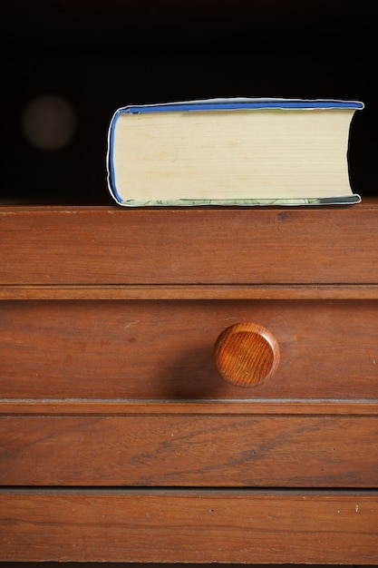 Foto zakboek in houten kastplank op donkere achtergrond met ruimte voor tekst