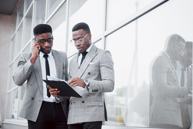 Zakelijke communicatie. Twee vrolijke zakenmannen praten met elkaar en bespreken een project