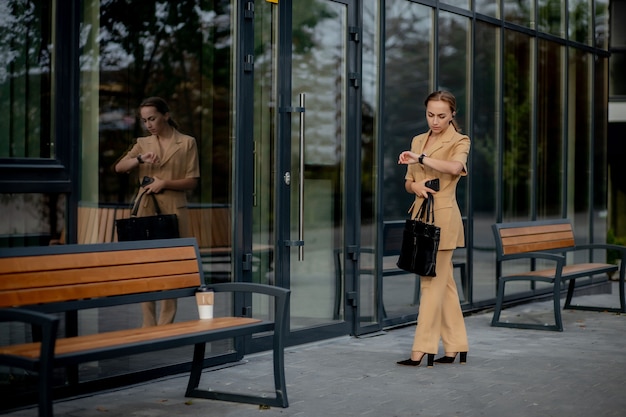 Zakelijke vrouwenstijl. Vrouw die met werkmap gaat werken. Portret van mooie glimlachende vrouw in stijlvolle kantoorkleding. Hoge resolutie.