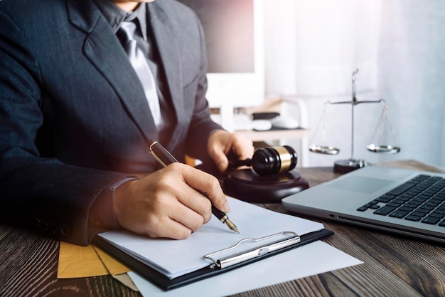 Zaken en advocaten bespreken contractpapieren met koperen schaal op bureau in kantoor Wet juridische diensten advies rechtvaardigheid en wet concept foto met filmkorreleffect