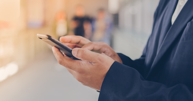 Zakenman Aziatische gebruikende telefoon voor celling en texting op haar mobiele telefoon