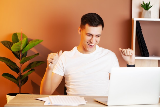 Zakenman die in het bureau bij laptop werkt