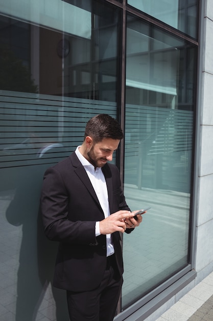 Zakenman die mobiele telefoon met behulp van