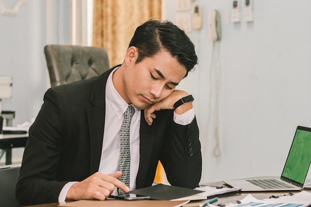 Foto zakenman die smartphone in het bureau gebruikt